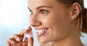 Woman placing Invisalign tray