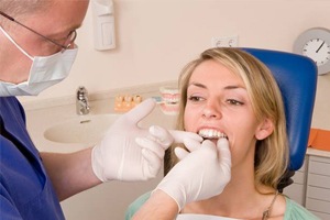 Woman in dental chair fitted for clear aligner
