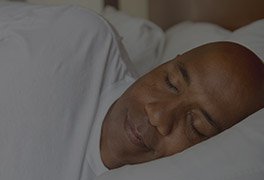 Man sleeping soundly in bed